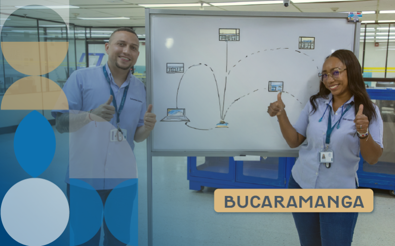 A woman and a man working in front of a whiteboard